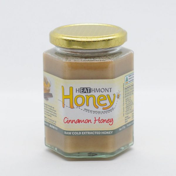Medium sized glass jar of cinnamon infused into honey